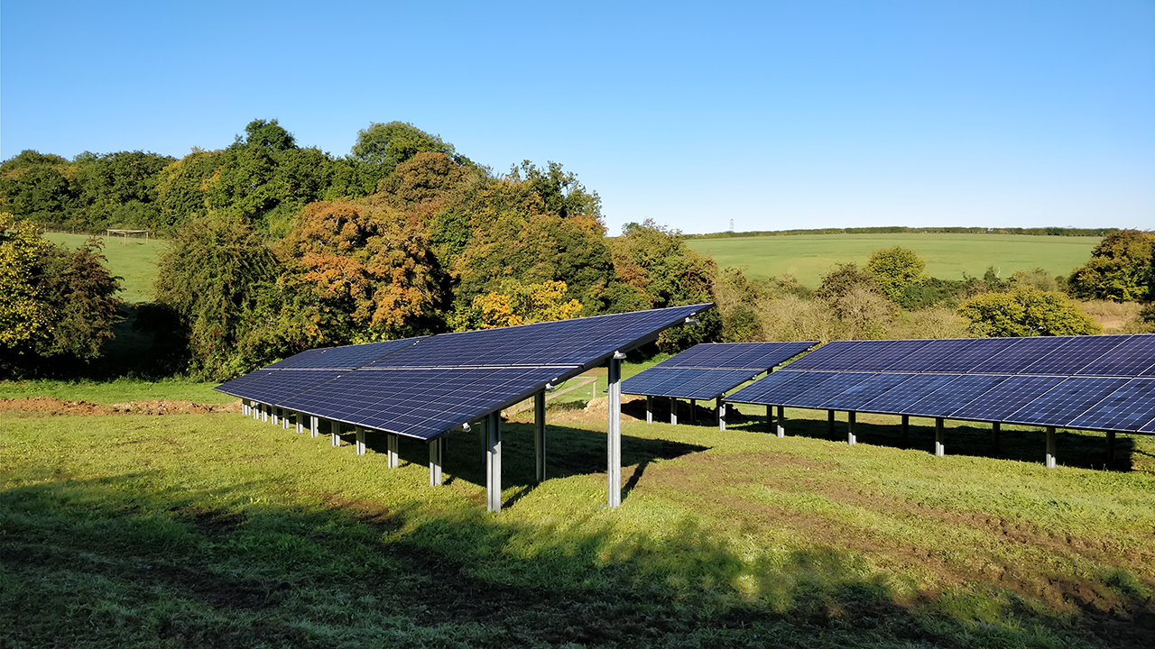 Ground mounted solar panel array in field